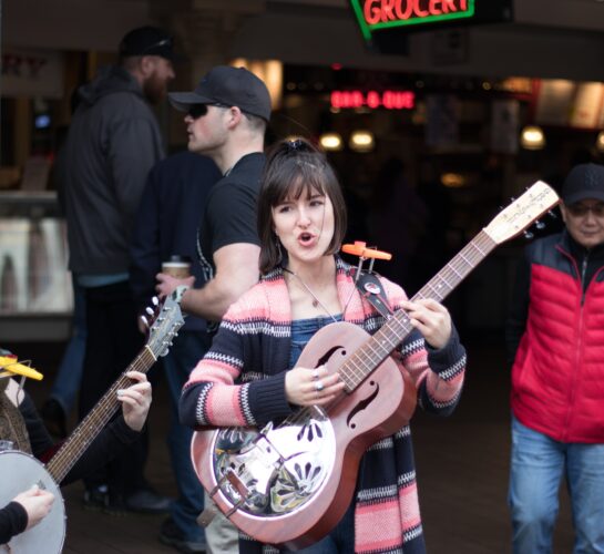 women singing and playing guitars