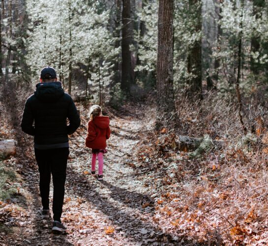 father and daughter walking in woods swanage