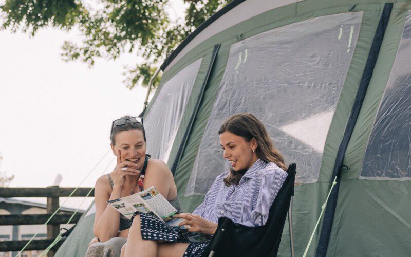 family sat outside tent