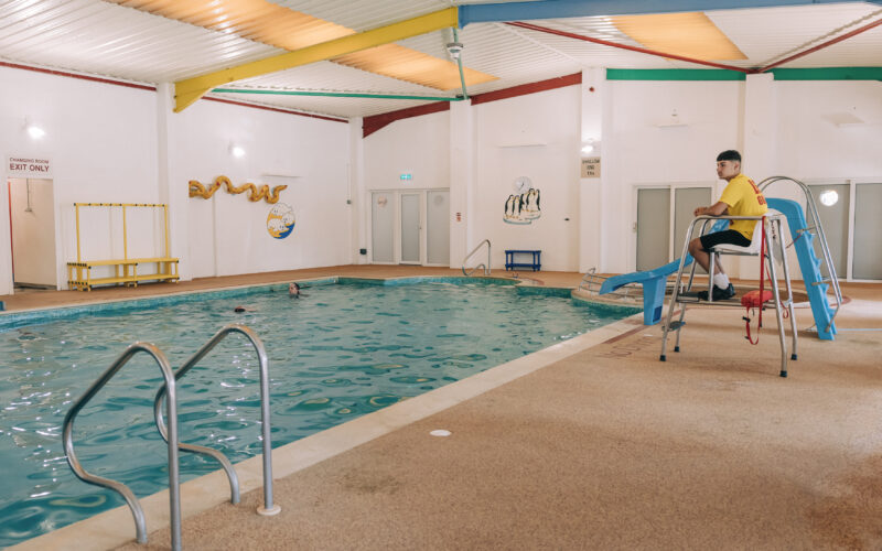 lifeguard overlooking indoor swimming pool ulwell